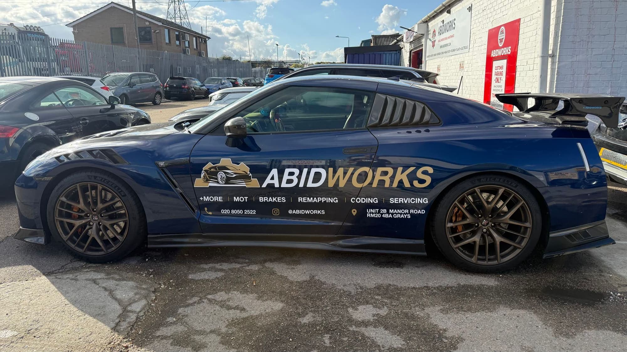 Blue Nissan GT-R in Abidworks livery on the forecourt in Grays