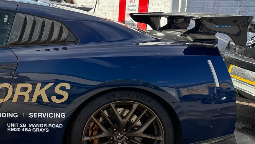 Rear wing of a blue Nissan GT-R at Abidworks, Grays