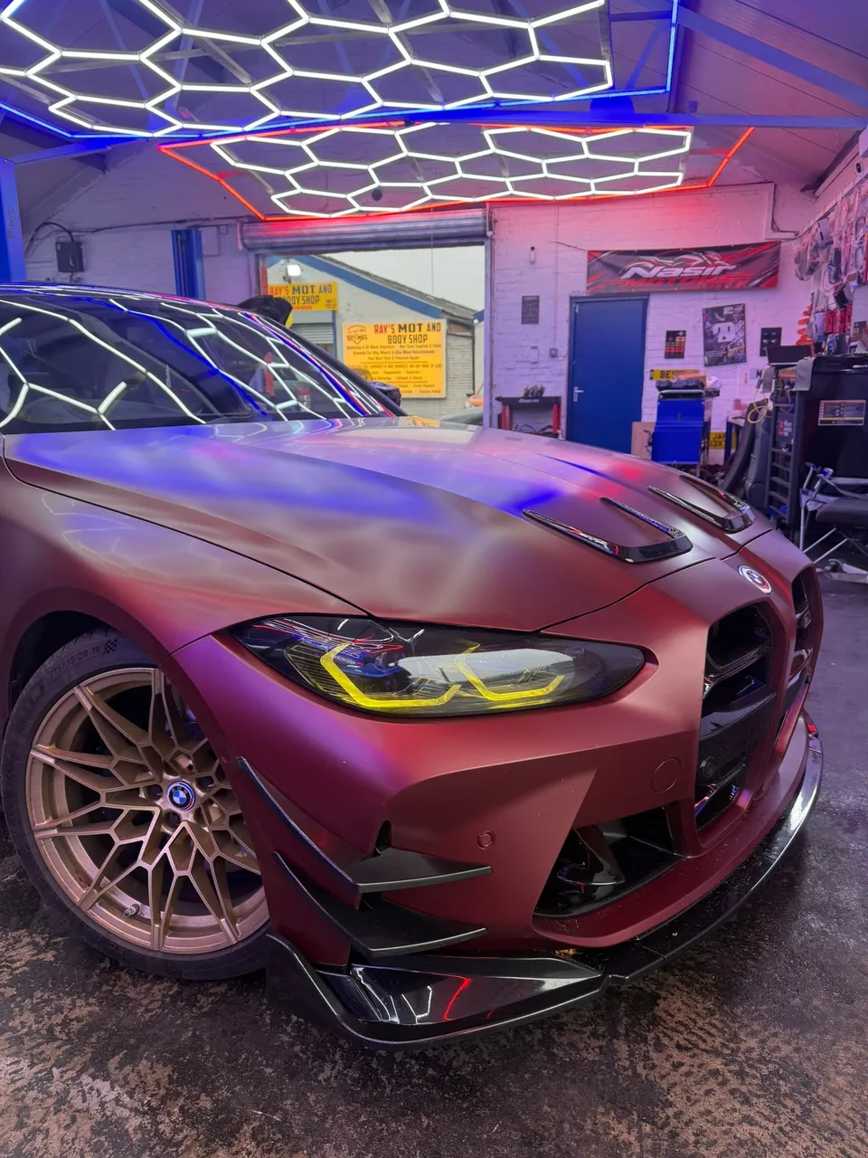 Front of the BMW M3 with its yellow daytime running lights, on the ramp at AbidWorks