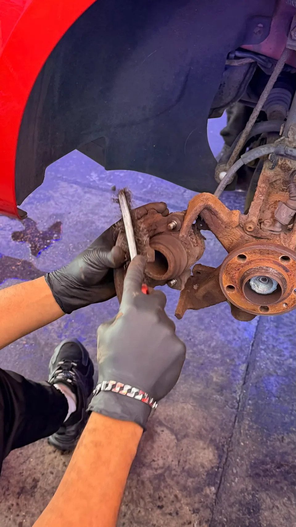 Brake caliper being worked on with the wheel off