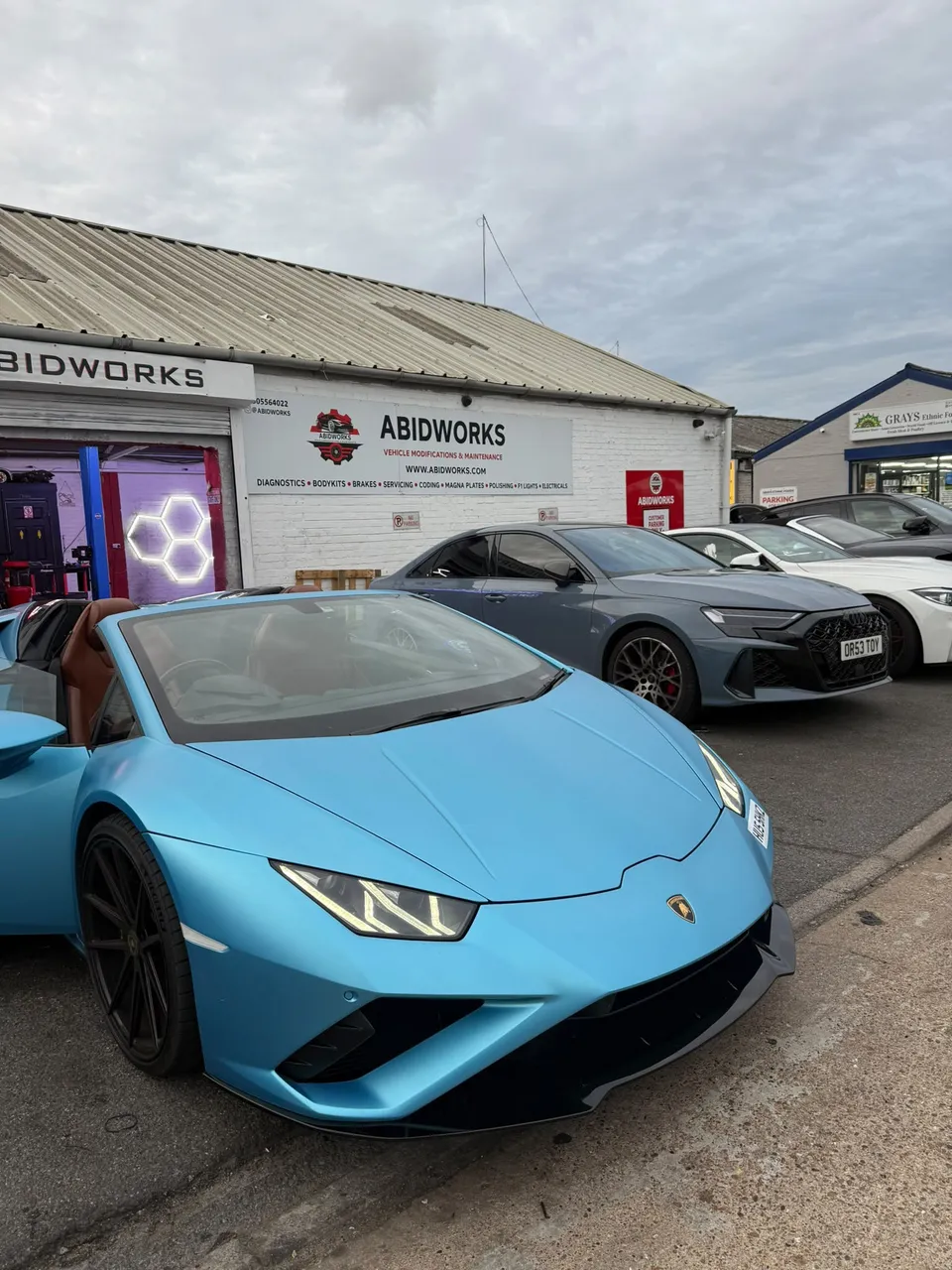 Light blue Lamborghini Huracán convertible outside the Abidworks workshop