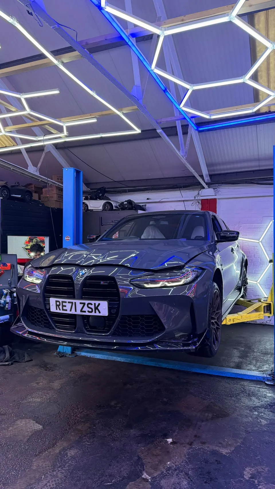 Grey BMW M3 on the ramp under the hex lights