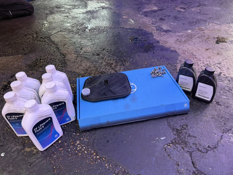 Genuine parts for the job: six litres of ZF Lifeguard Fluid 8, a ZF sump pan and filter kit with new bolts, and two bottles of BMW Hypoid Axle Oil G5